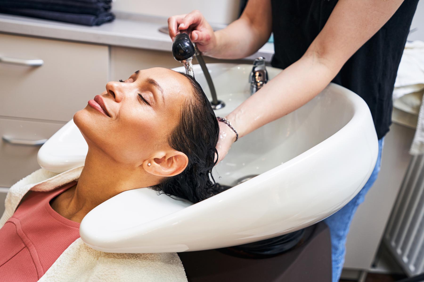 close up of beauty master washing hair